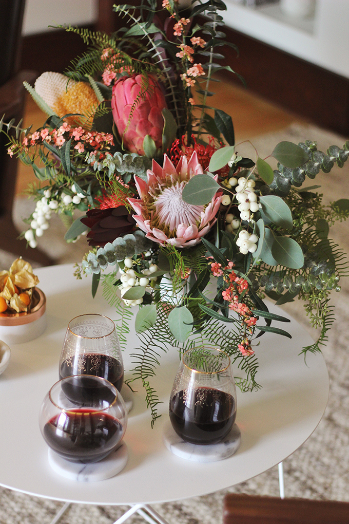 A Cozy Girls Night In | An eclectic November’s arrangement made with Euphorbia, Snowberries, King Protea, Banksia, Pin Cushions, Safari Sunset Leucodendron, Coral Fern and a trio of Seeded, Baby and Silver Dollar Eucalyptus // JustineCelina.com