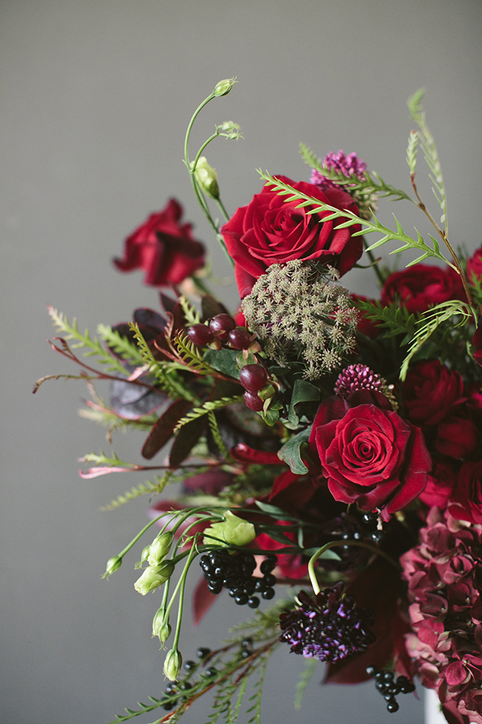 Luxe Holiday Floral Inspiration | Moody Winter Flower Arrangement with Black Magic Roses, Black Baccara Roses Gem and Lace Spray Garden Roses, Liqustrom, Hypericum, Allium, Lisianthus, Scabiosa, Chocolate Lace, Cotinus, Photina and Grevillea by Rebecca Dawn Design // JustineCelina.com