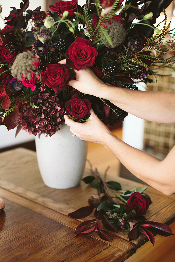 Luxe Holiday Floral Inspiration | Moody Winter Flower Arrangement with Black Magic Roses, Black Baccara Roses Gem and Lace Spray Garden Roses, Liqustrom, Hypericum, Allium, Lisianthus, Scabiosa, Chocolate Lace, Cotinus, Photina and Grevillea by Rebecca Dawn Design // JustineCelina.com