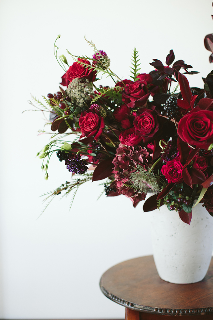 Luxe Holiday Floral Inspiration | Moody Winter Flower Arrangement with Black Magic Roses, Black Baccara Roses Gem and Lace Spray Garden Roses, Liqustrom, Hypericum, Allium, Lisianthus, Scabiosa, Chocolate Lace, Cotinus, Photina and Grevillea by Rebecca Dawn Design // JustineCelina.com