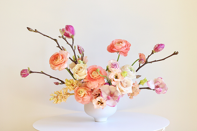 A Blushing Spring Arrangement with Coral Japanese Ranunculus, Lisianthus, Hyancith, Magnolia and Quicksand Roses | Spring Wedding Flower Ideas | Pantone Colour Trends Spring 2017 // JustineCelina.com