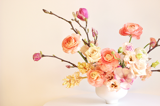 A Blushing Spring Arrangement with Coral Japanese Ranunculus, Lisianthus, Hyancith, Magnolia and Quicksand Roses | Spring Wedding Flower Ideas | Pantone Colour Trends Spring 2017 // JustineCelina.com