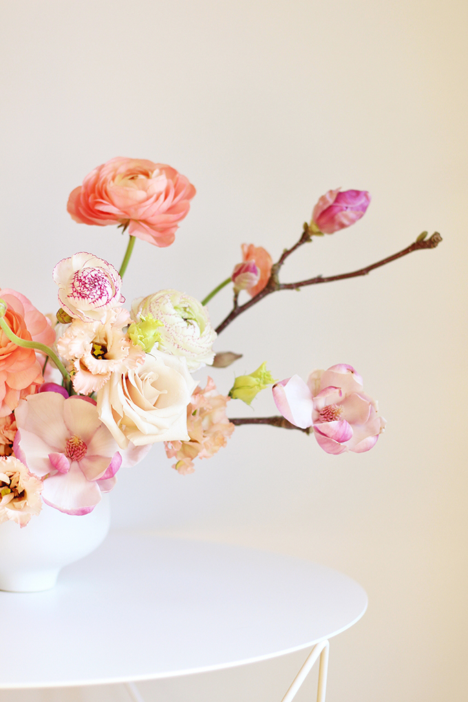 A Blushing Spring Arrangement with Coral Japanese Ranunculus, Lisianthus, Hyancith, Magnolia and Quicksand Roses | Spring Wedding Flower Ideas | Pantone Colour Trends Spring 2017 // JustineCelina.com