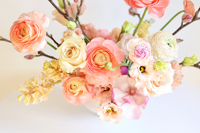 A Blushing Spring Arrangement with Coral Japanese Ranunculus, Lisianthus, Hyancith, Magnolia and Quicksand Roses | Spring Wedding Flower Ideas | Pantone Colour Trends Spring 2017 // JustineCelina.com