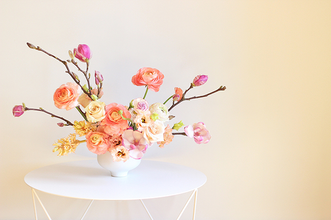 A Blushing Spring Arrangement with Coral Japanese Ranunculus, Lisianthus, Hyancith, Magnolia and Quicksand Roses | Spring Wedding Flower Ideas | Pantone Colour Trends Spring 2017 // JustineCelina.com