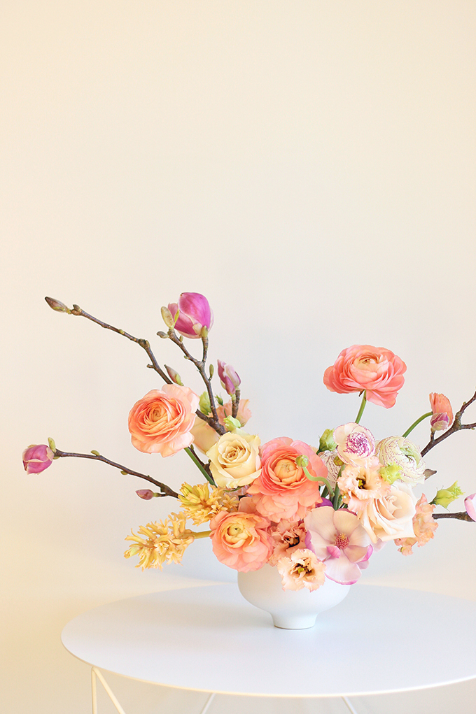 A Blushing Spring Arrangement with Coral Japanese Ranunculus, Lisianthus, Hyancith, Magnolia and Quicksand Roses | Spring Wedding Flower Ideas | Pantone Colour Trends Spring 2017 // JustineCelina.com