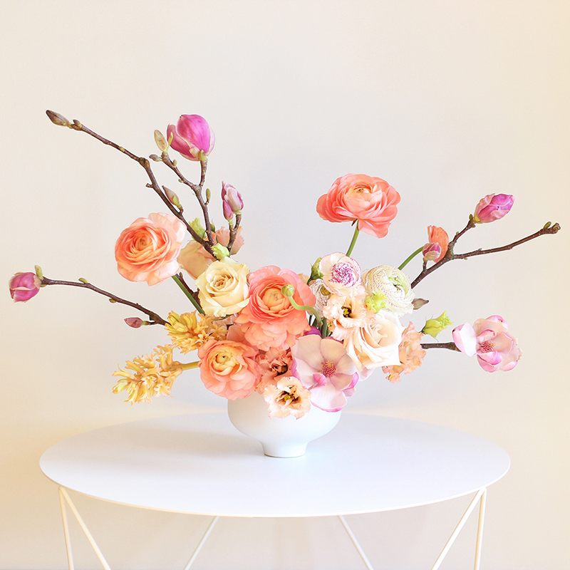 A Blushing Spring Arrangement with Coral Japanese Ranunculus, Lisianthus, Hyancith, Magnolia and Quicksand Roses | Spring Wedding Flower Ideas | Pantone Colour Trends Spring 2017 // JustineCelina.com
