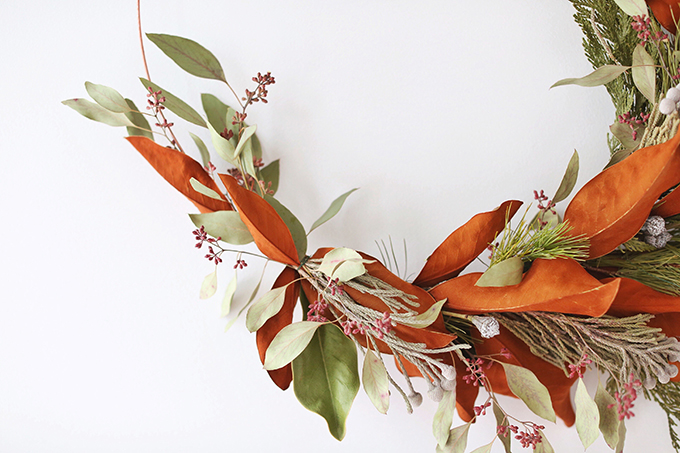 DIY | Asymmetrical Holiday Wreath | How to Make an Asymmetrical Holiday Wreaths for Christmas with Pine, Cedar, Brunia, Eucalyptus pods, Red Ironbark Eucalyptus and Magnolia | Christmas Wreath DIY | Modern Christmas Wreath DIY // JustineCelina.com