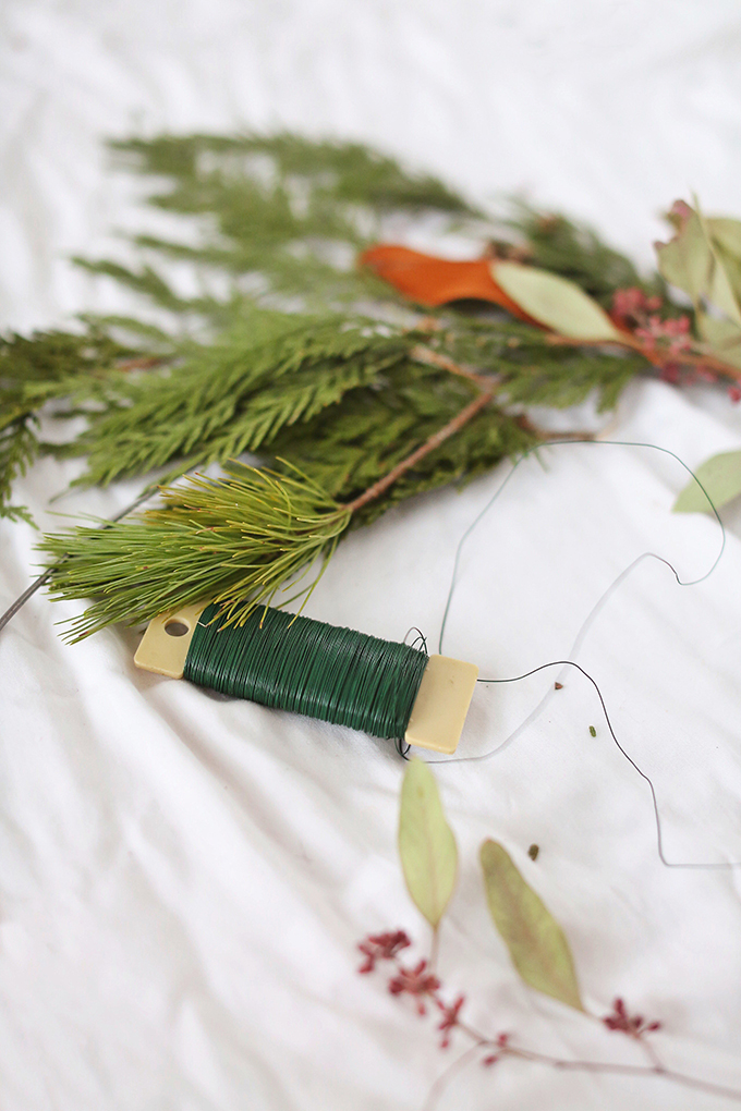 DIY | Asymmetrical Holiday Wreath | How to Make an Asymmetrical Holiday Wreaths for Christmas with Pine, Cedar, Brunia, Eucalyptus pods, Red Ironbark Eucalyptus and Magnolia | Christmas Wreath DIY | Modern Christmas Wreath DIY // JustineCelina.com