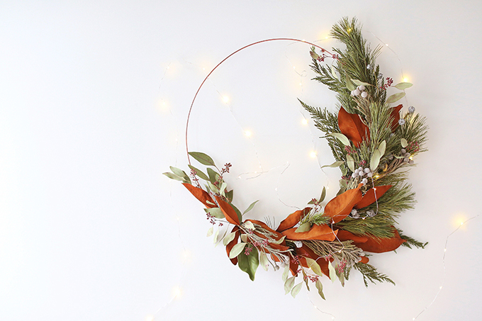 DIY | Asymmetrical Holiday Wreath | How to Make an Asymmetrical Holiday Wreaths for Christmas with Pine, Cedar, Brunia, Eucalyptus pods, Red Ironbark Eucalyptus and Magnolia | Christmas Wreath DIY | Modern Christmas Wreath DIY // JustineCelina.com