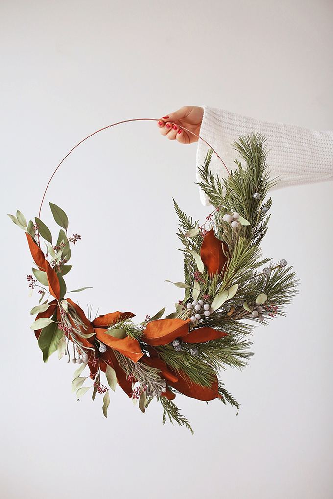 DIY | Asymmetrical Holiday Wreath | How to Make an Asymmetrical Holiday Wreaths for Christmas with Pine, Cedar, Brunia, Eucalyptus pods, Red Ironbark Eucalyptus and Magnolia | Christmas Wreath DIY | Modern Christmas Wreath DIY // JustineCelina.com