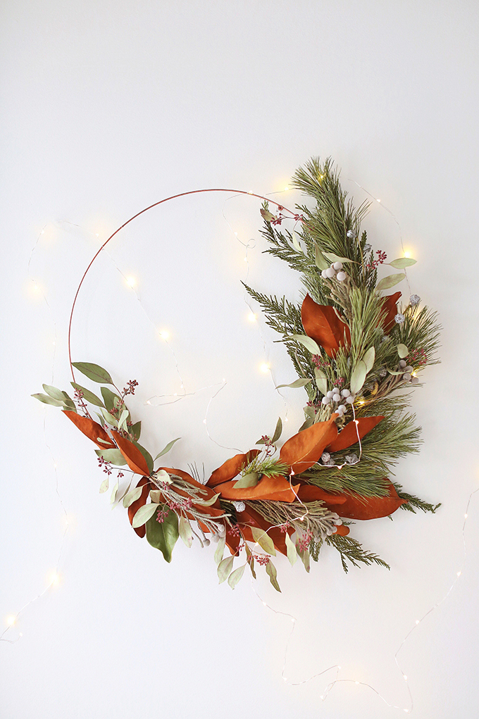 DIY | Asymmetrical Holiday Wreath | How to Make an Asymmetrical Holiday Wreaths for Christmas with Pine, Cedar, Brunia, Eucalyptus pods, Red Ironbark Eucalyptus and Magnolia | Christmas Wreath DIY | Modern Christmas Wreath DIY // JustineCelina.com