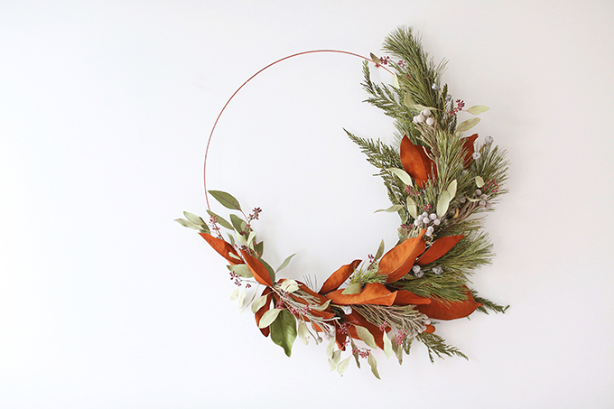 DIY | Asymmetrical Holiday Wreath | How to Make an Asymmetrical Holiday Wreaths for Christmas with Pine, Cedar, Brunia, Eucalyptus pods, Red Ironbark Eucalyptus and Magnolia | Christmas Wreath DIY | Modern Christmas Wreath DIY // JustineCelina.com