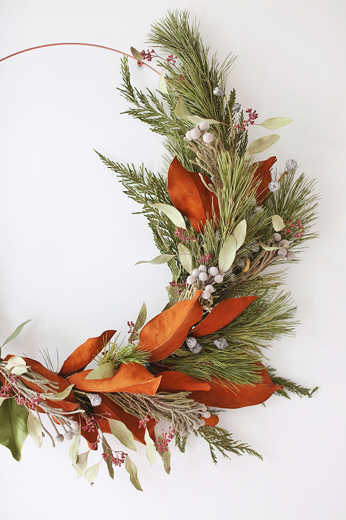 DIY | Asymmetrical Holiday Wreath | How to Make an Asymmetrical Holiday Wreaths for Christmas with Pine, Cedar, Brunia, Eucalyptus pods, Red Ironbark Eucalyptus and Magnolia | Christmas Wreath DIY | Modern Christmas Wreath DIY // JustineCelina.com