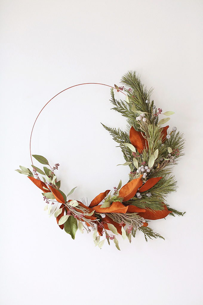 DIY | Asymmetrical Holiday Wreath | How to Make an Asymmetrical Holiday Wreaths for Christmas with Pine, Cedar, Brunia, Eucalyptus pods, Red Ironbark Eucalyptus and Magnolia | Christmas Wreath DIY | Modern Christmas Wreath DIY // JustineCelina.com