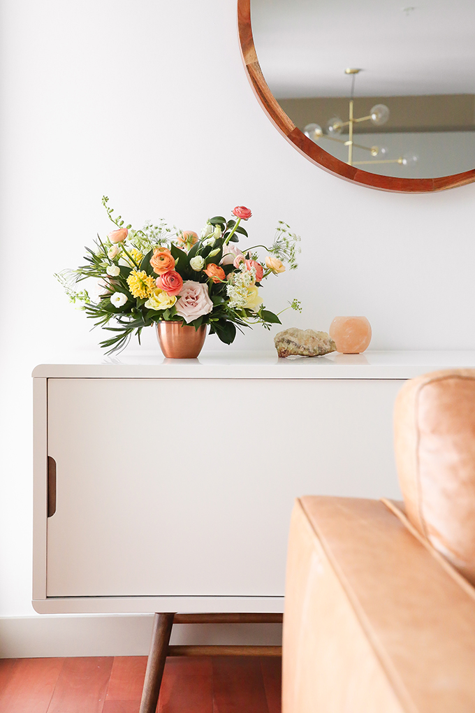 How to Unite a Space With Flowers | A Cheerful Spring Arrangement featuring Hyacinths, Double tulips, Ranunculus, Larkspur, Queen Anne’s Lace, Quicksand roses, Lisianthus, Camellia, Willow Eucalyptus and Podocarpus created by Rebecca Dawn Design // JustineCelina.com