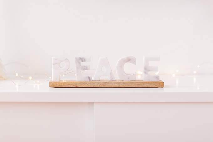 Apartment Friendly Modern Holiday Decor | Balsam & Fir Marble PEACE Sign | Bohemian, Mid Century Modern Holiday Decor | Bohemian Holiday Home Tour 2018 | Caramel Mid Century Modern Leather Couches // JustineCelina.com