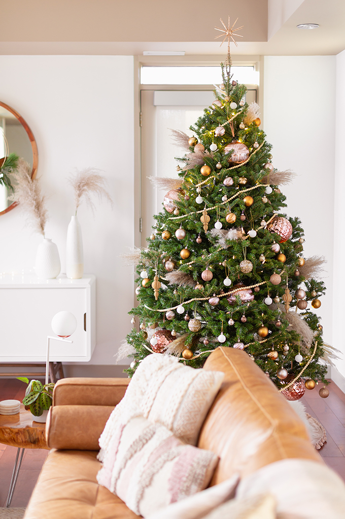 Apartment Friendly Modern Holiday Decor | Real Christmas Tree with Wood Garland, Metallic and Wood Ornaments and Pampas Grass | Premium Nova Scotia Balsam Fir Tree | Bohemian, Mid Century Modern Holiday Decor | Bohemian Holiday Home Tour 2018 | Caramel Mid Century Modern Leather Couches | Canadian Tire CANVAS Ornaments // JustineCelina.com