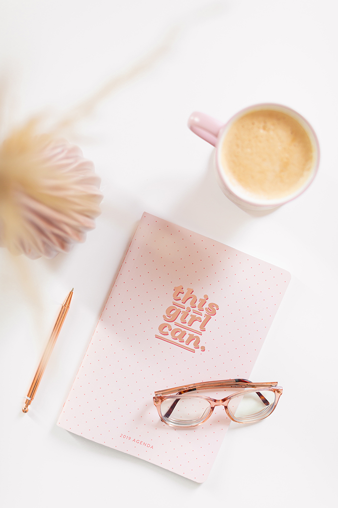 2018 Review + 2019 Goals | Calgary Lifestyle Blogger | 2019 Planning and Goal Setting | Entrepreneur Working from Home | HomeSense Fringe This Girl Can 2019 Agenda | Nespresso Coffee on a White Coffee Table | 2019 Motivational Goals Flatlay | Bonlook Lauren Blue Light Blocking Glasses In Peach // JustineCelina.com