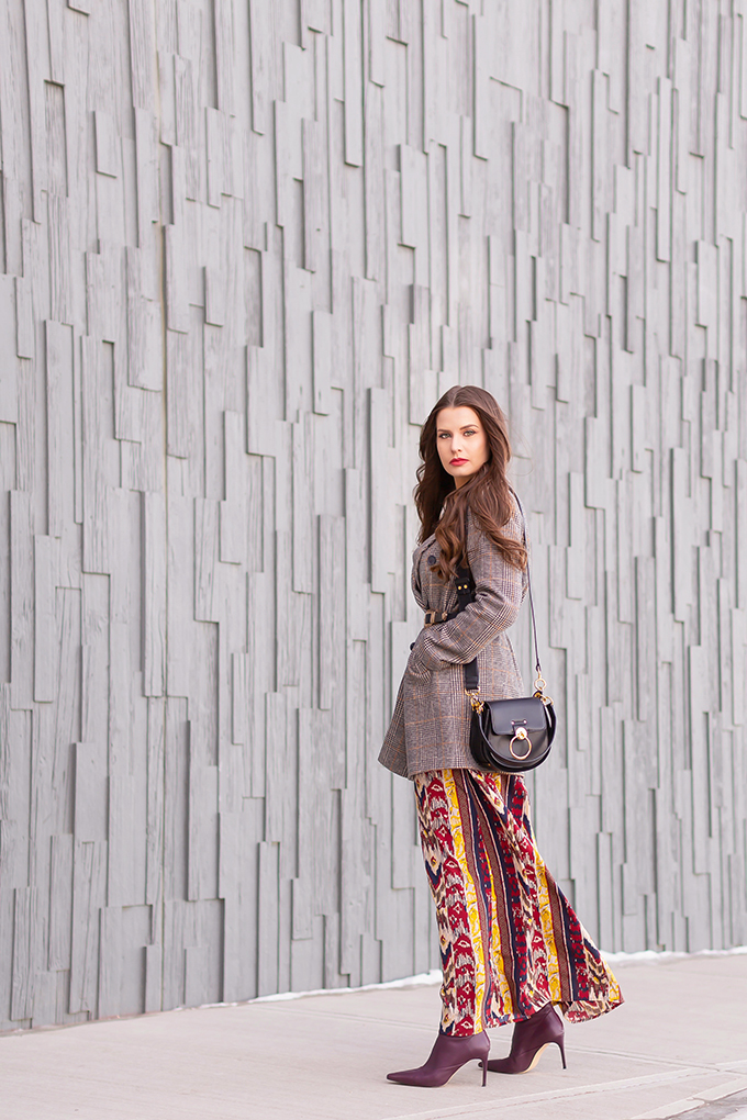 Winter 2019 Lookbook | Belted Blazer: How to Style Maxi Dresses for Winter | Brunette Girl wearing an ikat maxi dress, Checked Boyfriend Blazer, Black Chloe Tess Dupe the Artisan Anything Lara Leather Crossbody In Black, burgundy leather sock boots and a double buckle western belt | Bohemian Winter Style Ideas | Pantone Spring Summer 2019 Fashion Ideas | Creative Professional Outfit Ideas | Calgary, Alberta, Canada Fashion & Lifestyle Blogger // JustineCelina.com