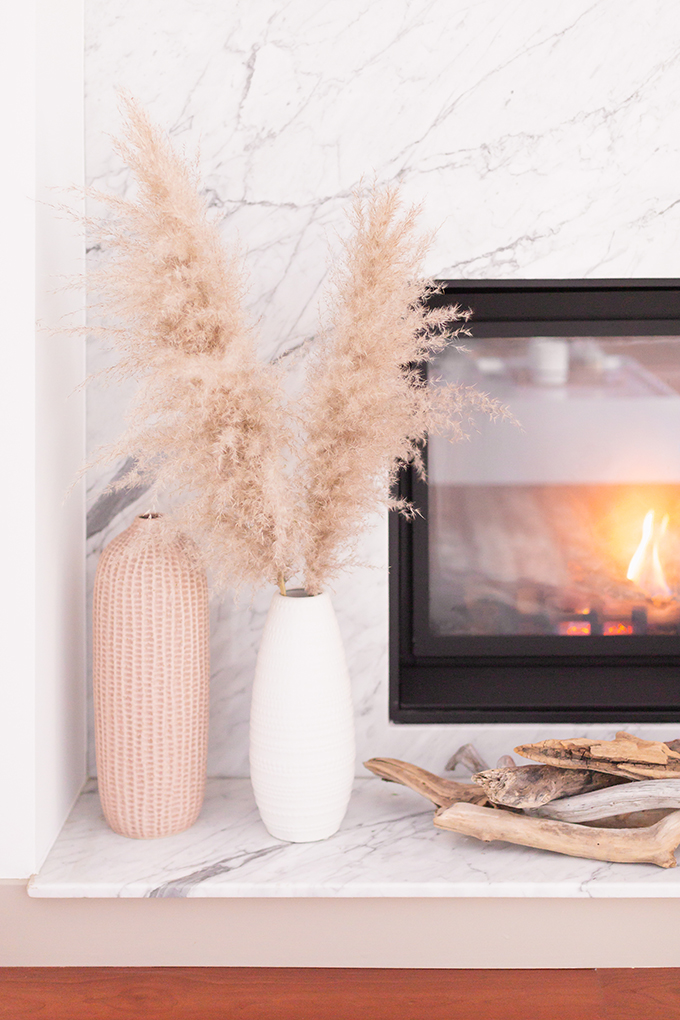 February 2019 Soundtrack | A cozy, modern marble fireplace decorated with driftwood and vases with pampas grass | Bohemian, Mid Century Modern Decor | Calgary Lifestyle Blogger // JustineCelina.com