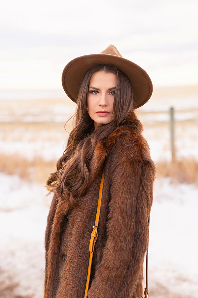 Pre Spring 2019 Trend Guide Bohemian Rhapsody: How to Style Midi Dresses for Transitional Spring Weather | Brunette Girl Standing in a Country Field at Sunrise Wearing a Brown Faux Fur Coat and Brown Wide Brim Hat | Bohemian Early Spring Style Ideas | Pantone Spring Summer 2019 Fashion Ideas | Calgary, Alberta, Canada Fashion & Lifestyle Blogger // JustineCelina.com