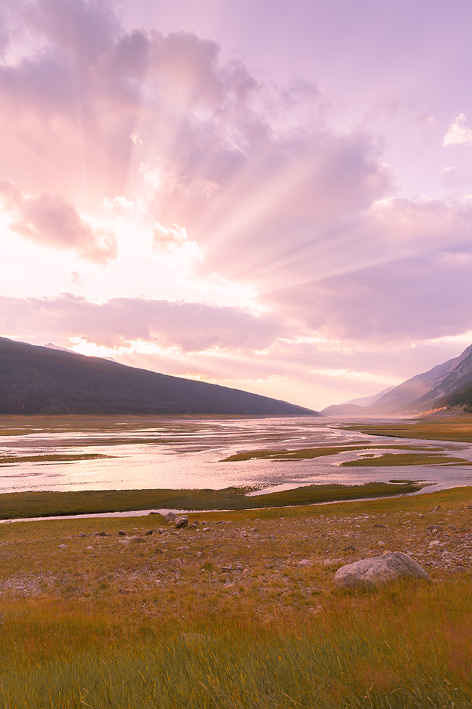 Early spring sunset spilling onto Medicine Lake near Jasper Alberta as the valley thaws | Calgary, Alberta Travel Blogger | Calgary, Alberta Music Blogger | Sunset over Canadian Rocky Mountains in Jasper National Park | March 2019 Soundtrack // JustineCelina.com