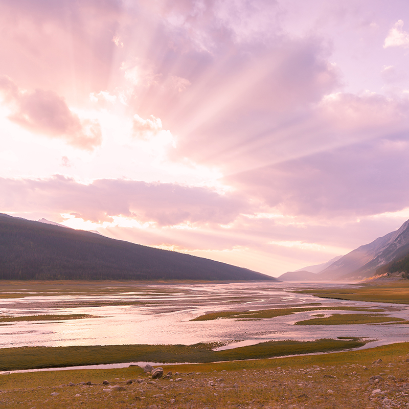 Early spring sunset spilling onto Medicine Lake near Jasper Alberta as the valley thaws | Calgary, Alberta Travel Blogger | Calgary, Alberta Music Blogger | Sunset over Canadian Rocky Mountains in Jasper National Park | March 2019 Soundtrack // JustineCelina.com