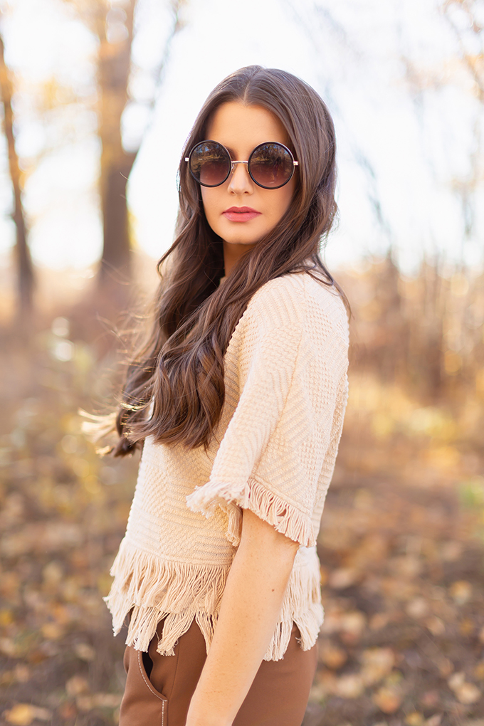 WORK WEAR | SPRING 2019 TRENDS AT THE OFFICE | How to Style Culottes for the Office | Brown 70’s Style Culottes with a Mustard Faux Suede Jacket, Knit Fringe Hem Top, Natural Material Zara Rattan Woven Box Bag and Leopard Print D’Orsay Heels | Brunette girl wearing round black sunglasses | Spring 2019 Trends | Office Appropriate Spring Outfit Ideas // JustineCelina.com