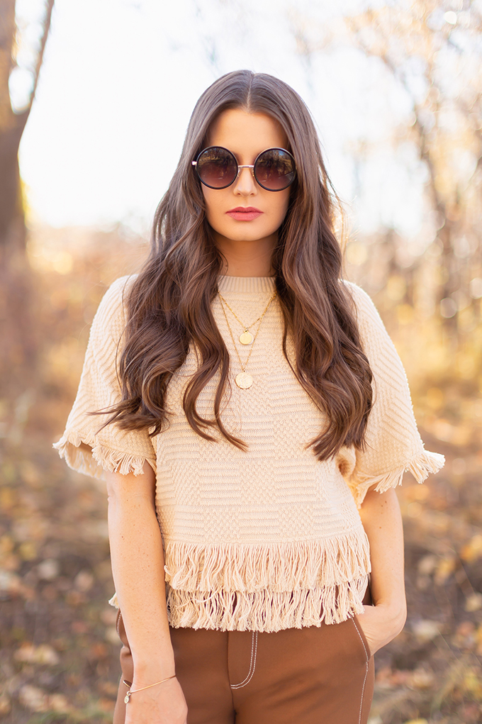 WORK WEAR | SPRING 2019 TRENDS AT THE OFFICE | How to Style Culottes for the Office | Brown 70’s Style Culottes with a Mustard Faux Suede Jacket, Knit Fringe Hem Top, Natural Material Zara Rattan Woven Box Bag and Leopard Print D’Orsay Heels | Brunette girl wearing round black sunglasses | Spring 2019 Trends | Office Appropriate Spring Outfit Ideas // JustineCelina.com