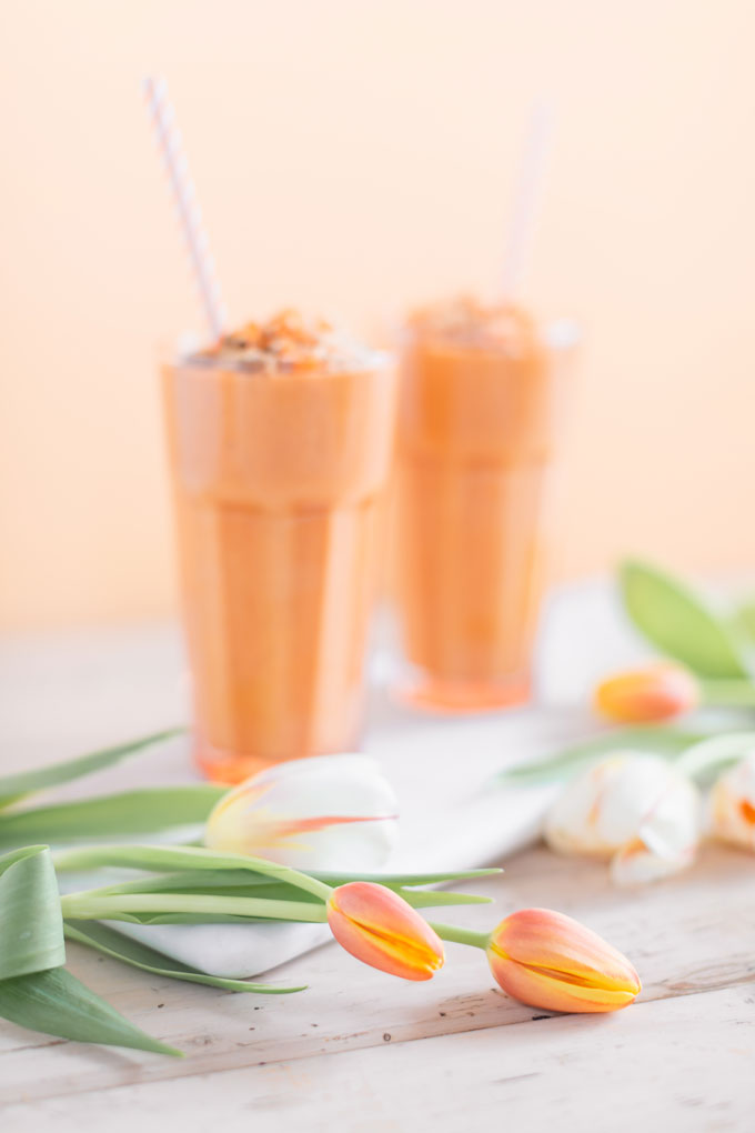 Vegan Cardamom Carrot Cake Smoothie | healthy carrot cake smoothie, cardamom carrot cake smoothie recipe, cardamom carrot cake smoothie vegan, cardamom carrot cake smoothie image, cardamom carrot cake smoothies, paleo carrot cake smoothie, vegan paleo carrot cake smoothie, the best vegan carrot cake smoothie, 2 carrot cake smoothies with spring tulips against a creamsicle orange pastel background and a marble serving board  | Calgary, Alberta Creative Lifestyle Blogger // JustineCelina.com