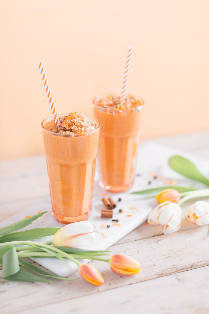 Vegan Cardamon Carrot Cake Smoothie | healthy carrot cake smoothie, cardamom carrot cake smoothie recipe, cardamom carrot cake smoothie vegan, cardamom carrot cake smoothie image, cardamom carrot cake smoothies, paleo carrot cake smoothie, vegan paleo carrot cake smoothie, the best vegan carrot cake smoothie, 2 carrot cake smoothies with spring tulips against a creamsicle orange pastel background and a marble serving board | Calgary, Alberta Creative Lifestyle Blogger // JustineCelina.com