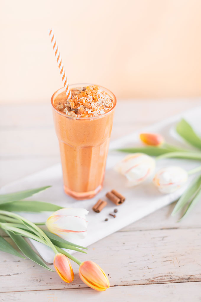 Vegan Cardamon Carrot Cake Smoothie | healthy carrot cake smoothie, cardamom carrot cake smoothie recipe, cardamom carrot cake smoothie vegan, cardamom carrot cake smoothie image, cardamom carrot cake smoothies, paleo carrot cake smoothie, vegan paleo carrot cake smoothie, the best vegan carrot cake smoothie, 2 carrot cake smoothies with spring tulips against a creamsicle orange pastel background and a marble serving board | Calgary, Alberta Creative Lifestyle Blogger // JustineCelina.com