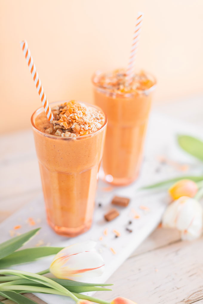 Vegan Cardamom Carrot Cake Smoothie | healthy carrot cake smoothie, cardamom carrot cake smoothie recipe, cardamom carrot cake smoothie vegan, cardamom carrot cake smoothie image, cardamom carrot cake smoothies, paleo carrot cake smoothie, vegan paleo carrot cake smoothie, the best vegan carrot cake smoothie, 2 carrot cake smoothies with spring tulips against a creamsicle orange pastel background and a marble serving board | Calgary, Alberta Creative Lifestyle Blogger // JustineCelina.com