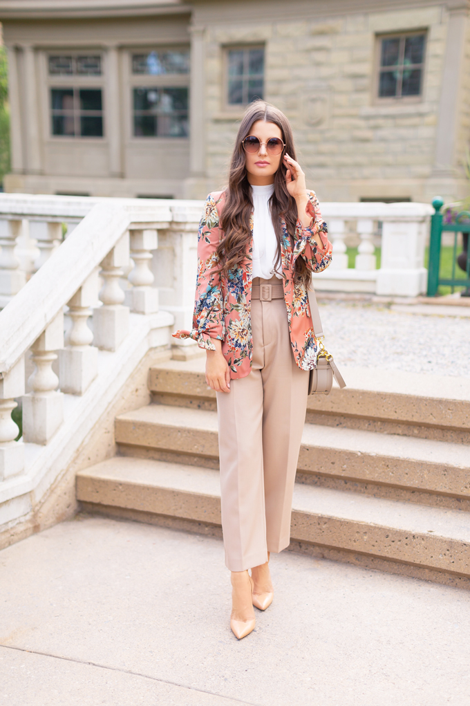 SPRING/SUMMER 2019 LOOKBOOK | Khaki Chic: How to Style Paperbag Pants at the Office for Spring | Paperbag Pant Outfit Ideas | Professional Spring/Summer 2019 Outfits | Brunette woman wearing high waisted khaki paperbag pants, a white top, a coral floral blazer, nude pointed toe pumps and Artisan Anything’s Chloe Tess dupe in grey | How to Wear the Paperbag pant Trend for SS19 | Top Spring/Summer 2019 Trends | Calgary Fashion Blogger // JustineCelina.com