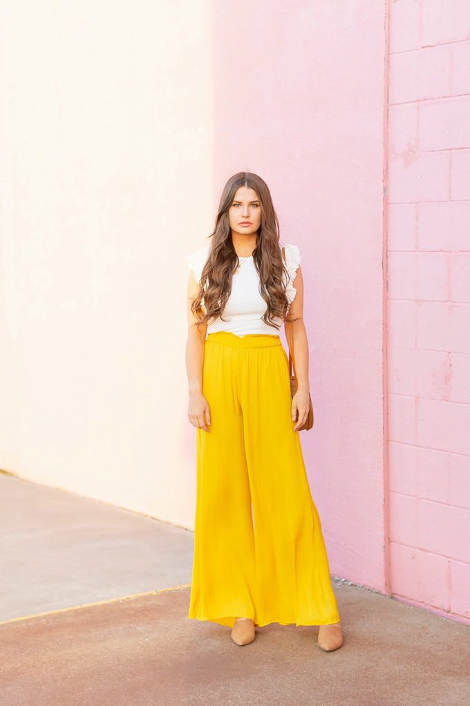 SPRING/SUMMER 2019 LOOKBOOK | Mellow Yellow: How to Style Yellow Palazzo Pants for Spring | Palazzo Pant Outfit Ideas Spring 2019 | Spring/Summer Summer Vacation Outfit Ideas | Brunette woman wearing a Yellow Palazzo Pants, a white ruffled sleeve top, a Round Women Bali Round Rattan Bag and Camel Mules | How to Wear palazzo pants for spring 2019 | Top Spring/Summer 2019 Trends and how to wear them | Calgary Fashion & Lifestyle Blogger // JustineCelina.com