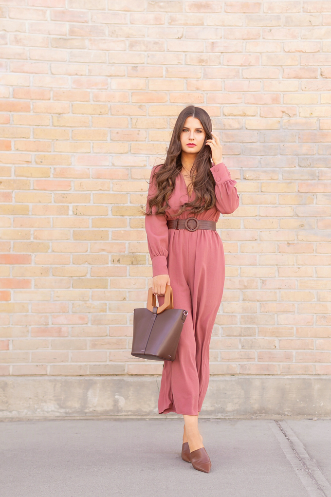 SPRING 2019 LOOKBOOK | Rosy Outlook: How to Style a Long Sleeve Mauve Jumpsuit for Spring | Jumpsuit Outfit Ideas Spring 2019 | How to Style a Jumpsuit for the Office | Brunette woman wearing a Long Sleeve Mauve Jumpsuit with a Brown Croc Embossed Bet styled, Zara Brown LEATHER MULES WITH GEOMETRIC HEELS and a Brown ZARA Wood Handled Structured Shopper against a brick wall | Top Spring 2019 Trends and how to wear them | Calgary Fashion & Creative Lifestyle Blogger // JustineCelina.com