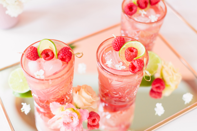 Raspberry Rhubarb Rosé Spritz | A refreshing, clean, refined sugar free cocktail | A summer-inspired trio of rhubarb, raspberries and honey combine in a scratch-made Honeyed Raspberry Rhubarb Syrup to infuse this effervescent cocktail with seasonal panache, beautifully complimented by sparkling rosé, soda water, fresh lime juice and a dash of bitters | Rosé spritzer recipe | Rosé cocktail | Rosé wine spritzer | summer cocktails with vodka // JustineCelina.com