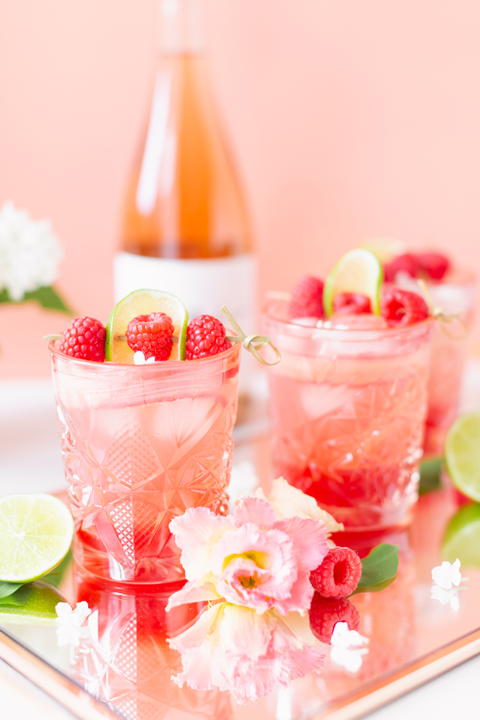 Raspberry Rhubarb Rosé Spritz | A refreshing, clean, refined sugar free cocktail | A summer-inspired trio of rhubarb, raspberries and honey combine in a scratch-made Honeyed Raspberry Rhubarb Syrup to infuse this effervescent cocktail with seasonal panache, beautifully complimented by sparkling rosé, soda water, fresh lime juice and a dash of bitters | Rosé spritzer recipe | Rosé cocktail | Rosé wine spritzer | summer cocktails with vodka // JustineCelina.com