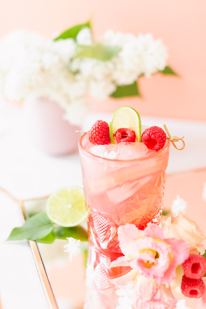 Raspberry Rhubarb Rosé Spritz | A refreshing, clean, refined sugar free cocktail | A summer-inspired trio of rhubarb, raspberries and honey combine in a scratch-made Honeyed Raspberry Rhubarb Syrup to infuse this effervescent cocktail with seasonal panache, beautifully complimented by sparkling rosé, soda water, fresh lime juice and a dash of bitters | Rosé spritzer recipe | Rosé cocktail | Rosé wine spritzer | summer cocktails with vodka // JustineCelina.com