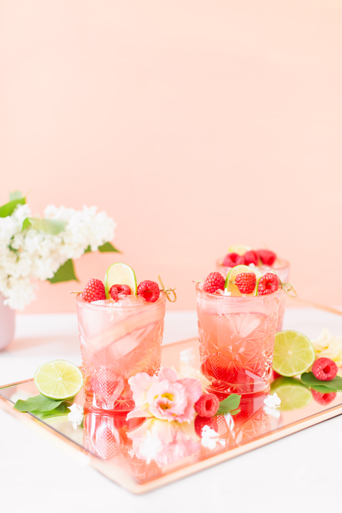 Raspberry Rhubarb Rosé Spritz | A refreshing, clean, refined sugar free cocktail | A summer-inspired trio of rhubarb, raspberries and honey combine in a scratch-made Honeyed Raspberry Rhubarb Syrup to infuse this effervescent cocktail with seasonal panache, beautifully complimented by sparkling rosé, soda water, fresh lime juice and a dash of bitters | Rosé spritzer recipe | Rosé cocktail | Rosé wine spritzer | summer cocktails with vodka // JustineCelina.com