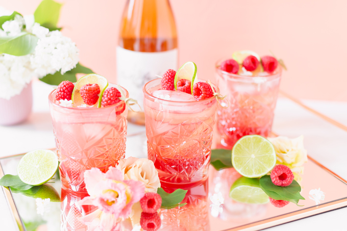 Raspberry Rhubarb Rosé Spritz | A refreshing, clean, refined sugar free cocktail | A summer-inspired trio of rhubarb, raspberries and honey combine in a scratch-made Honeyed Raspberry Rhubarb Syrup to infuse this effervescent cocktail with seasonal panache, beautifully complimented by sparkling rosé, soda water, fresh lime juice and a dash of bitters | Rosé spritzer recipe | Rosé cocktail | Rosé wine spritzer | summer cocktails with vodka // JustineCelina.com