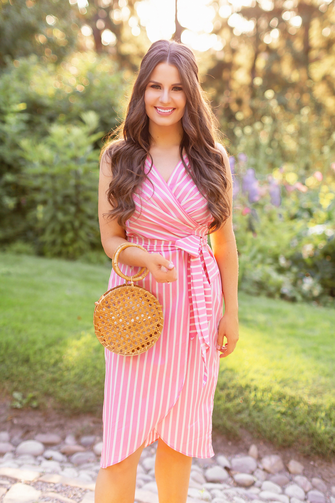 What to Wear to | A Casual Summer Wedding | Outdoor Summer Wedding Outfit Ideas | Brunette Woman wearing a Pantone Living Coral Wrap Dress with a Circular Bamboo Bracelet Bag | 3rd Floor Studio Isla Wrap Dress | How to Dress for a Casual Outdoor Summer Wedding | Summer Dresses to Wear to a Wedding | How to Wear Pantone Colour of the Year 2019 Living Coral | Reader Rock Park Calgary Wedding | Calgary Fashion and Lifestyle Blogger // JustineCelina.com