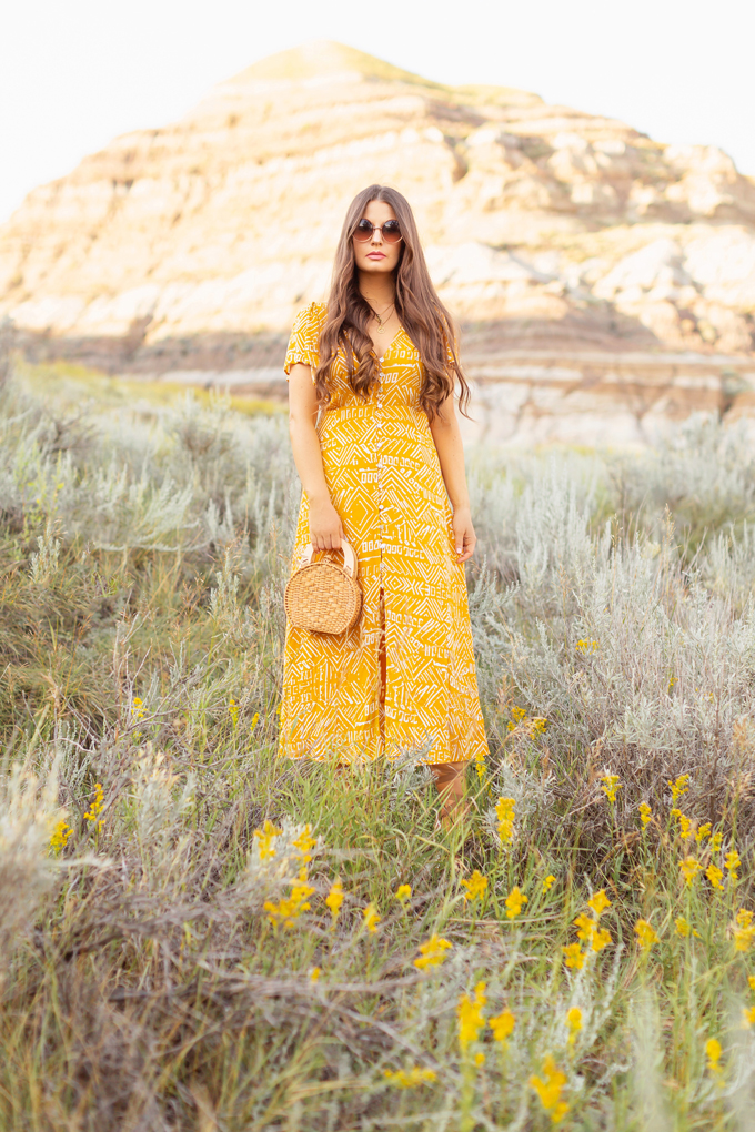 LATE SUMMER 2019 LOOKBOOK | Mustard Moment: How to Transition Midi Dresses into Autumn | How to Wear Summer Clothes in Fall | Brunette Woman wearing a button-down mustard Aztec print midi dress with a woven rattan bag and nude espadrilles | Top Summer to Fall 2019 Transitional Trends and how to wear them | HooDoos, Drumheller Bandlands, Alberta | Calgary Fashion Blogger // JustineCelina.com