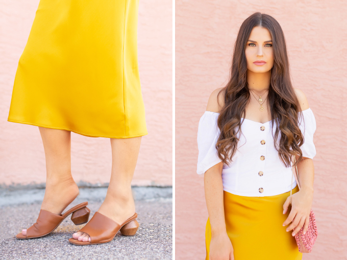 LATE SUMMER 2019 LOOKBOOK | Walking on Sunshine: How to Style TopShop’s Bias Cut Satin Midi Skirt for Summer / Autumn | TopShop Yellow Satin Skirt Outfit Ideas | Casual Daytime Transitional Outfit Ideas | Brunette woman wearing a Topshop Yellow Satin Midi Skirt styled with a white button-down Bardot top, brown leather mules with a wooden heel and a Pantone Living Coral beaded bag | Summer 2019 Trends | Calgary Fashion & Creative Lifestyle Blogger // JustineCelina.com