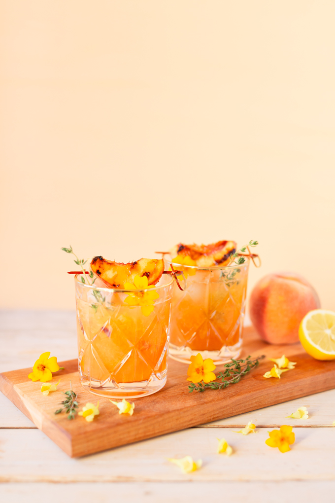 Smoked Peach Maple Bourbon Smash | A summer-meets-autumn sip juxtaposing juicy late summer fruit with a smoky grilled edge and spicy autumnal warmth | Dairy Free, Gluten Free and Refined Sugar Free -- and brimming with better-for-you ingredients! | The best fresh peach bourbon cocktail recipe | Grilled peach cocktail | Peach Bourbon Cocktail | Late summer bourbon cocktails | Southern Summer Peach Cocktail | Early Autumn Peach Cocktail | Autumn Equinox Cocktail Recipe // JustineCelina.com