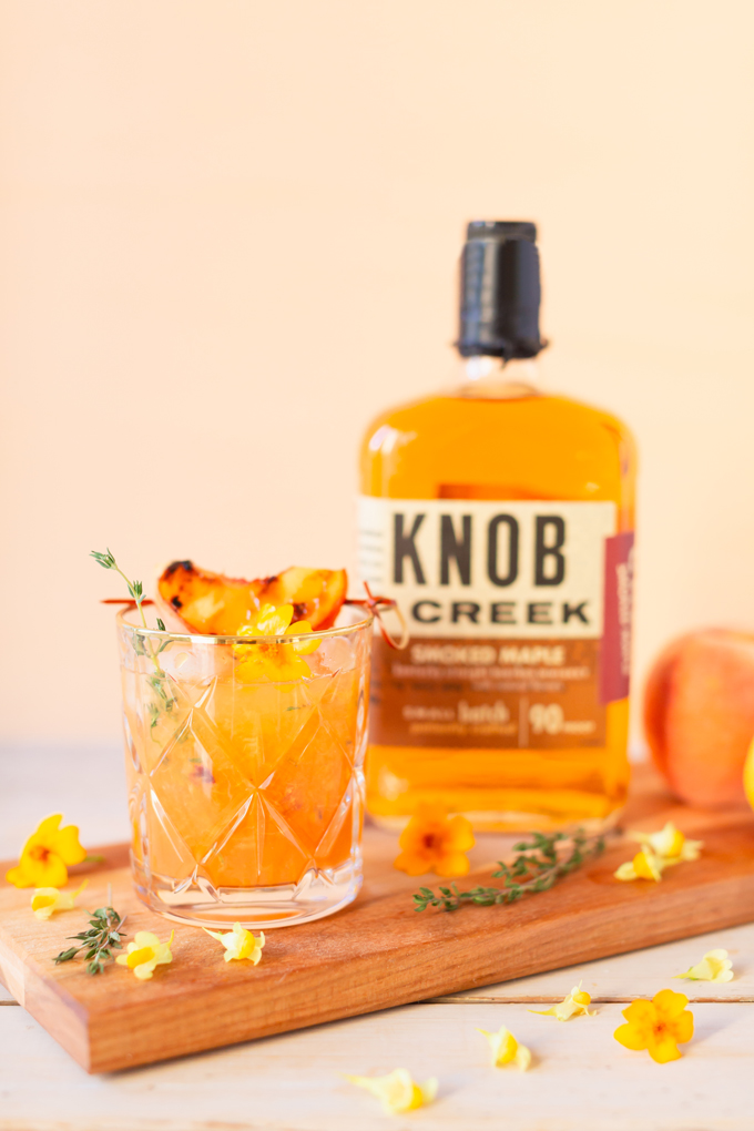 Smoked Peach Maple Bourbon Smash | A summer-meets-autumn sip juxtaposing juicy late summer fruit with a smoky grilled edge and spicy autumnal warmth | Dairy Free, Gluten Free and Refined Sugar Free -- and brimming with better-for-you ingredients! | The best fresh peach bourbon cocktail recipe | Grilled peach cocktail | Peach Bourbon Cocktail | Late summer bourbon cocktails | Southern Summer Peach Cocktail | Early Autumn Peach Cocktail | Autumn Equinox Cocktail Recipe // JustineCelina.com