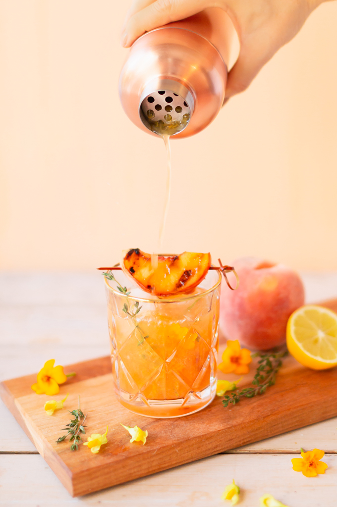 Smoked Peach Maple Bourbon Smash | A summer-meets-autumn sip juxtaposing juicy late summer fruit with a smoky grilled edge and spicy autumnal warmth | Dairy Free, Gluten Free and Refined Sugar Free -- and brimming with better-for-you ingredients! | The best fresh peach bourbon cocktail recipe | Grilled peach cocktail | Peach Bourbon Cocktail | Late summer bourbon cocktails | Southern Summer Peach Cocktail | Early Autumn Peach Cocktail | Autumn Equinox Cocktail Recipe // JustineCelina.com