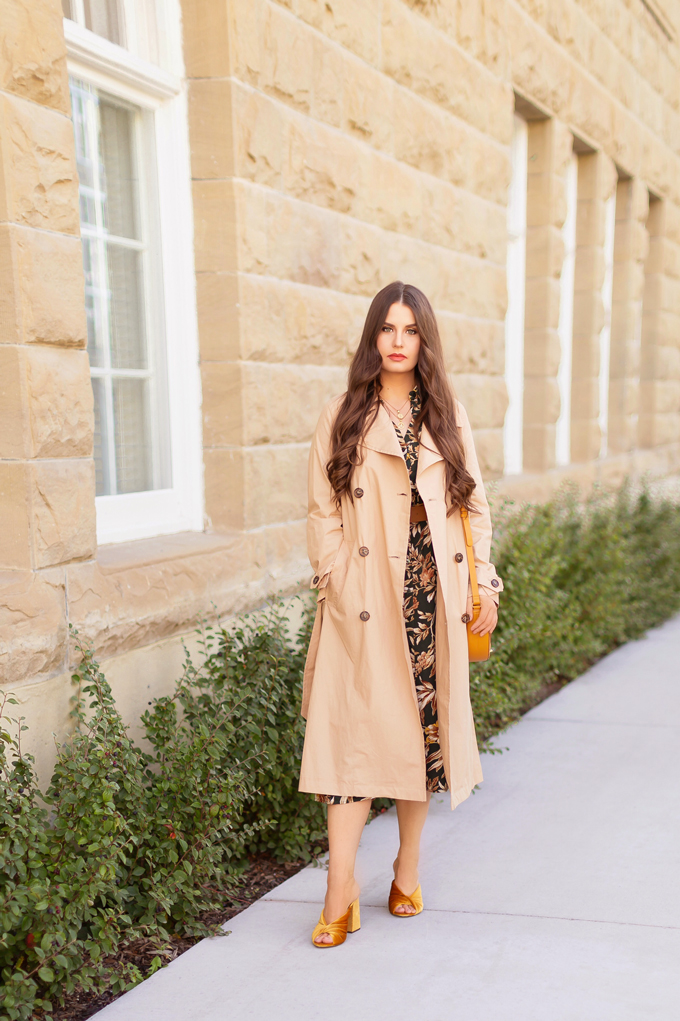Summer to Fall 2019 Transitional Lookbook | Top Summer to Fall 2019 Transitional Trends | Top Autumn 2019 Trends and How to Wear Them | The Best Dresses for Work | Fall 2019 Professional Outfit Ideas | Brunette woman wearing an H&M Dark Green Floral Button-Down Midi Dress, Mustard Velvet Block Heeled Sandals, Mustard Leather Bag, a Mango Leather Belt with Wooden Buckle and a Mango Trenchcoat | Top Calgary Fashion & Creative Lifestyle Blogger // JustineCelina.com