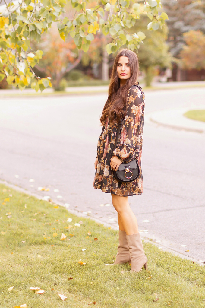 Summer to Fall 2019 Transitional Lookbook : Moody Florals | Top Summer to Fall 2019 Transitional Trends | Top Autumn 2019 Trends and How to Wear Them | The Best Moody Floral Dresses for Fall | | Brunette woman wearing an H&M Wide Cut Chiffon Floral Dress, Zara Taupe Mid-Calf Suede Boots, A Black Chloe Tess Dupe by Artisan Anything, Round Black Sunglasses and a Dark Red Lip | Top Calgary Fashion & Creative Lifestyle Blogger // JustineCelina.com